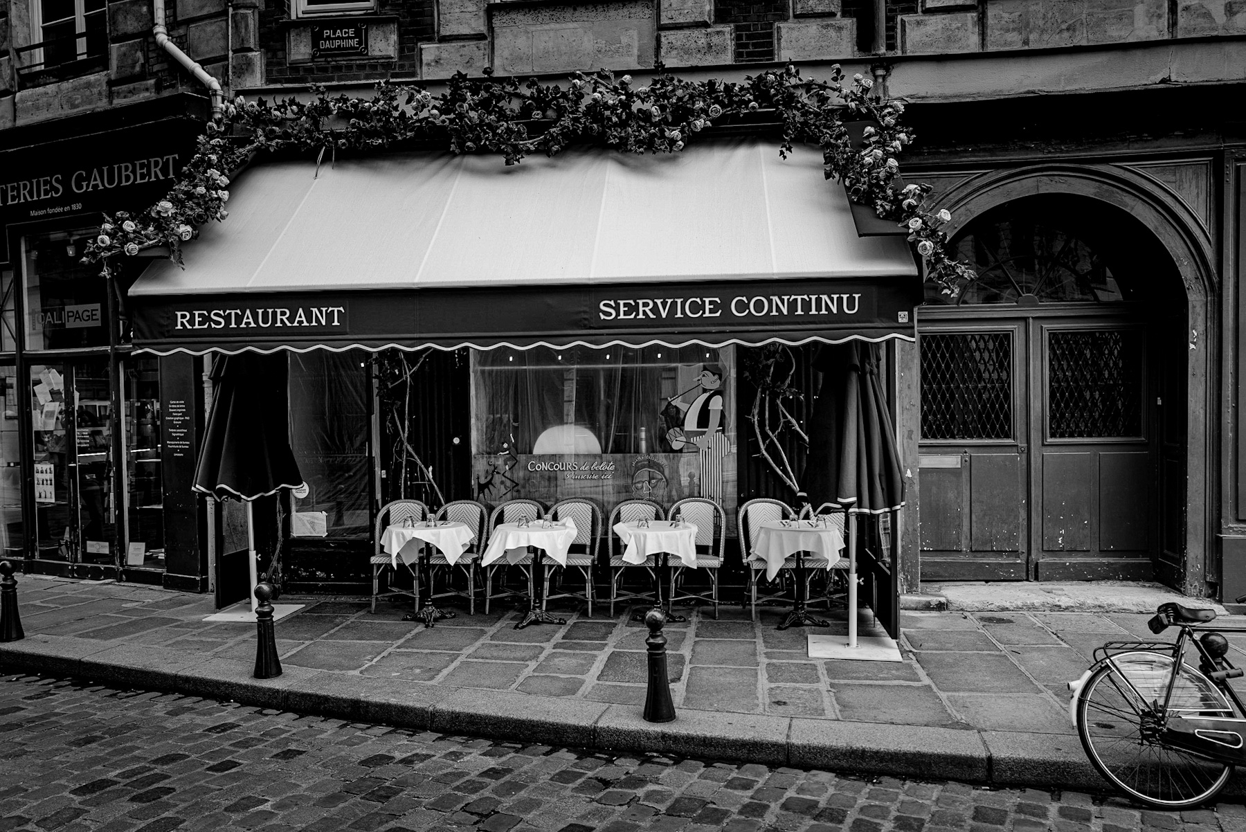 A Timeless Parisian Scene: Restaurant Charm and Historical Echoes