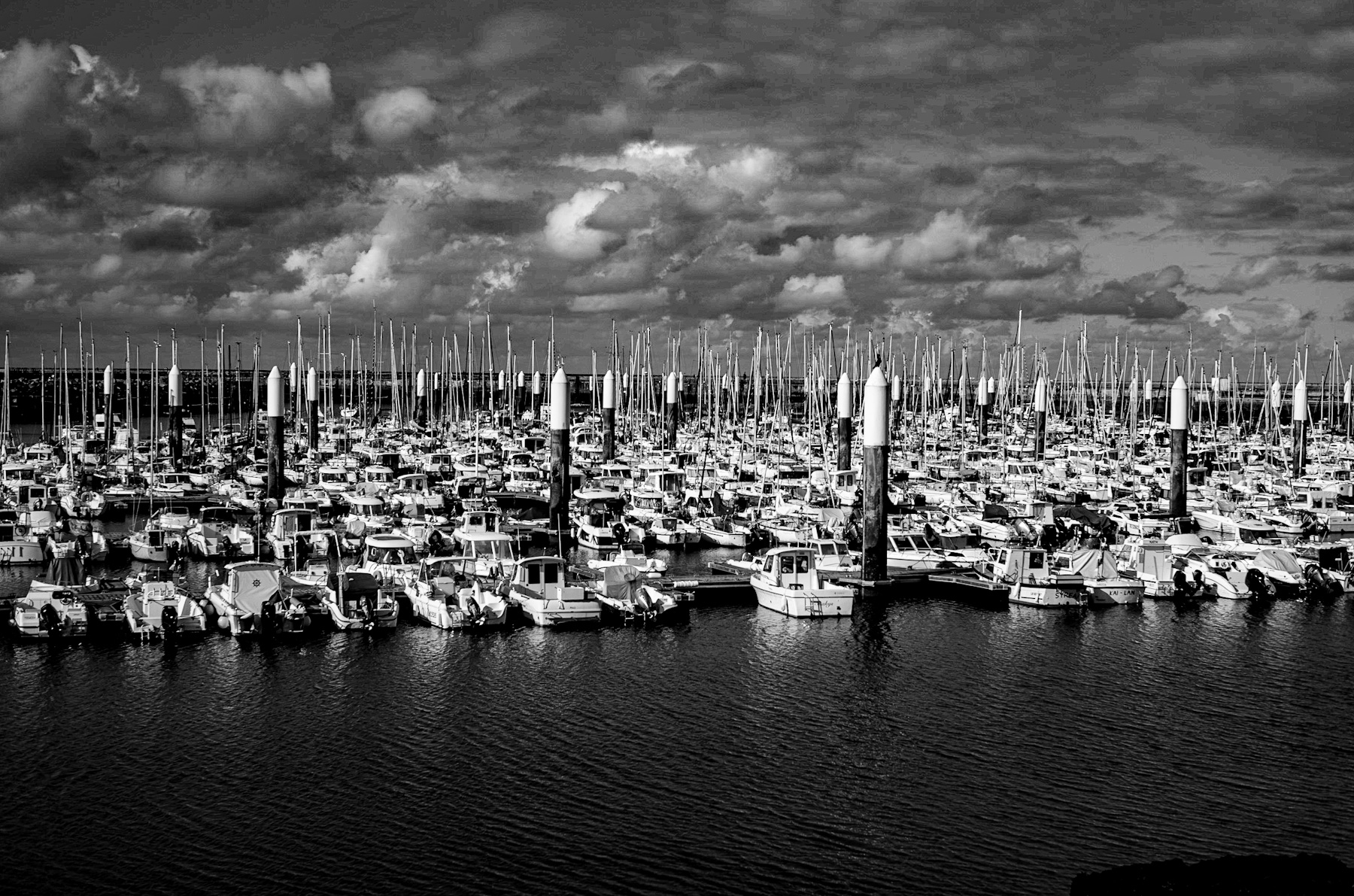 Echoes of the Sea: A Marina’s Timeless Narrative in Monochrome